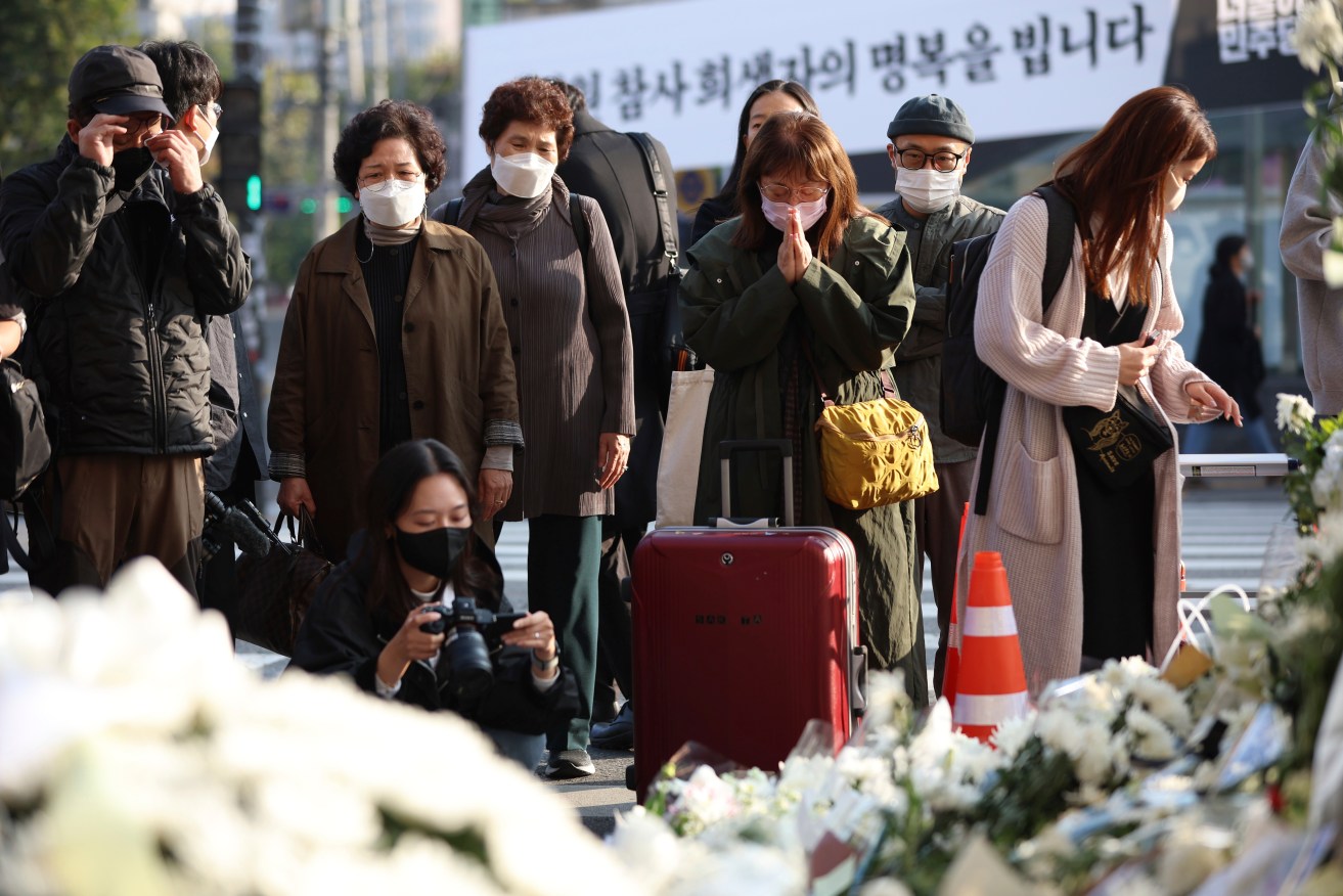 Mourners have gathered at the scene of the crush in Seoul that killed 156 people. 