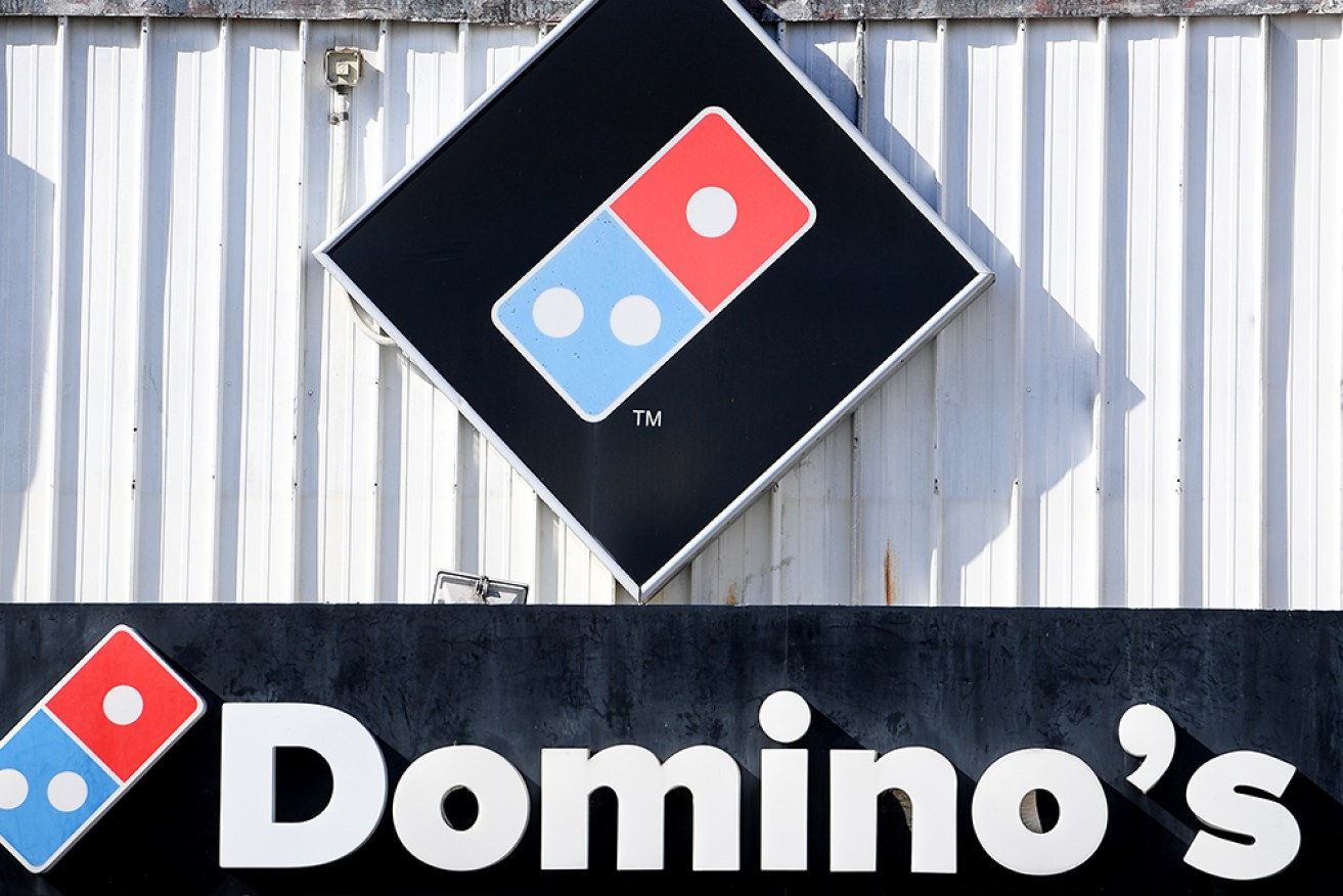 An ex-Domino's delivery driver claims he and more than 50,000 workers were underpaid for years. 