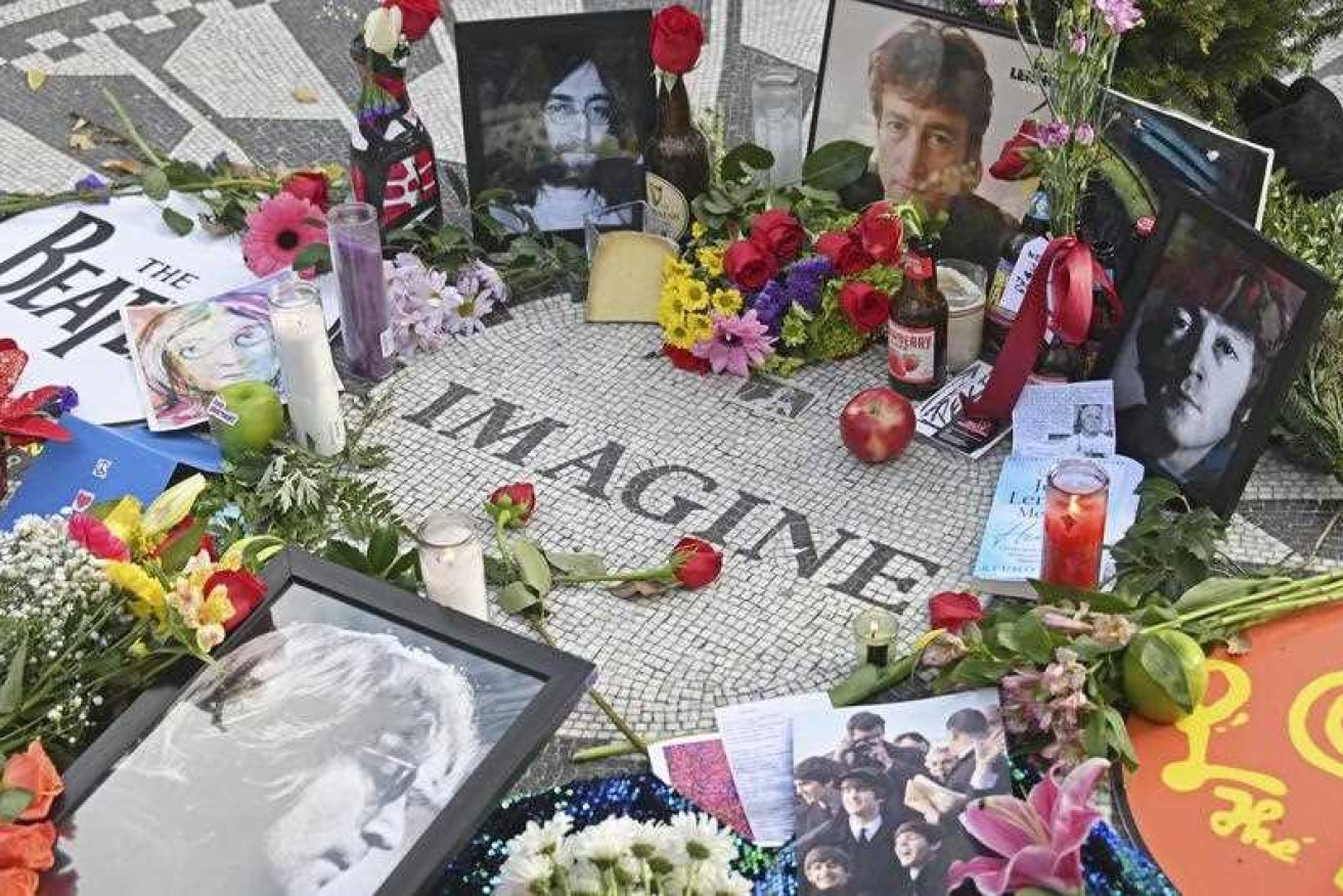 Flowers are left at John Lennon's memorial, Strawberry Fields, in New York's Central Park on December 8, 2020, the 40th anniversary of the legendary musician's death.