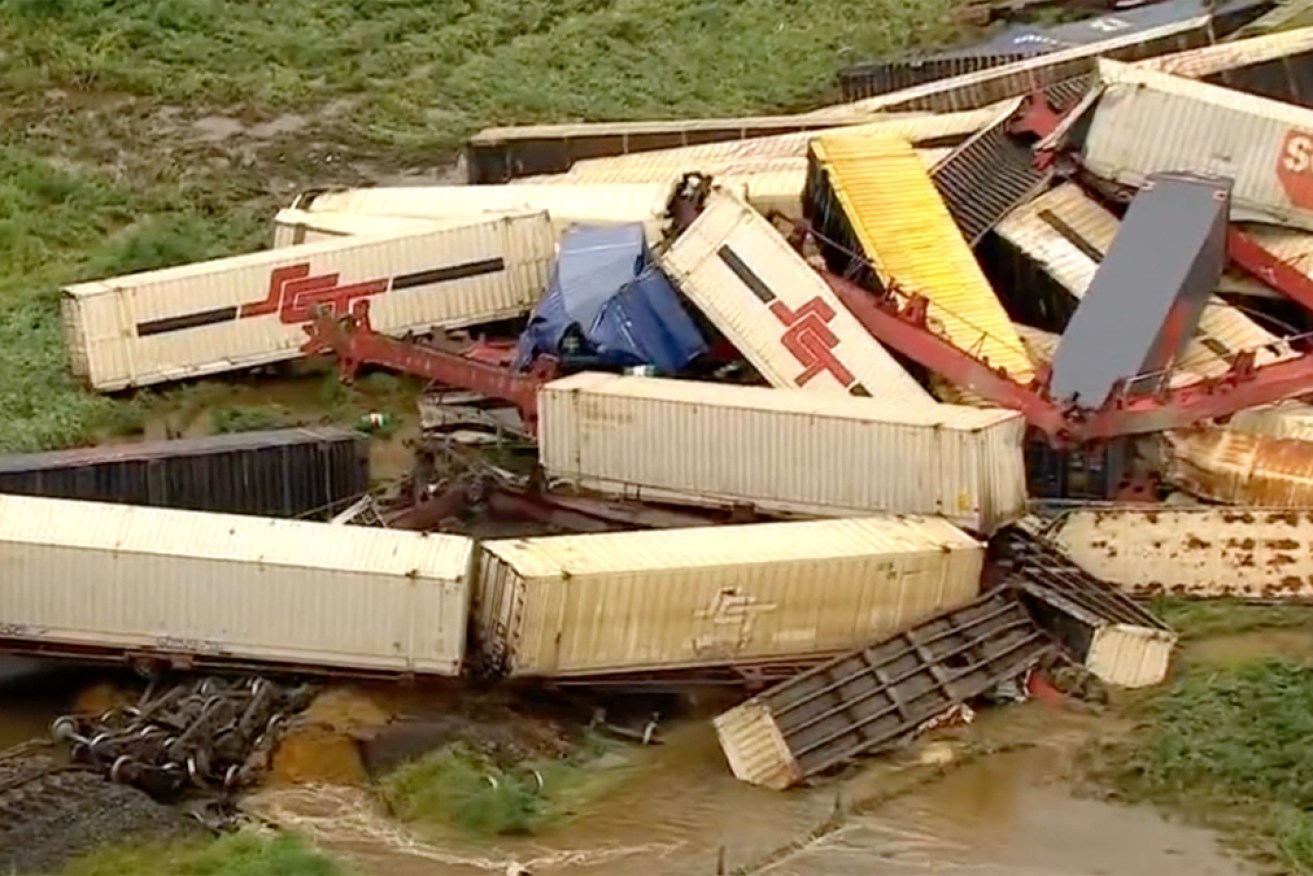 Shipping containers were strewn across the rail line after Monday's derailment.