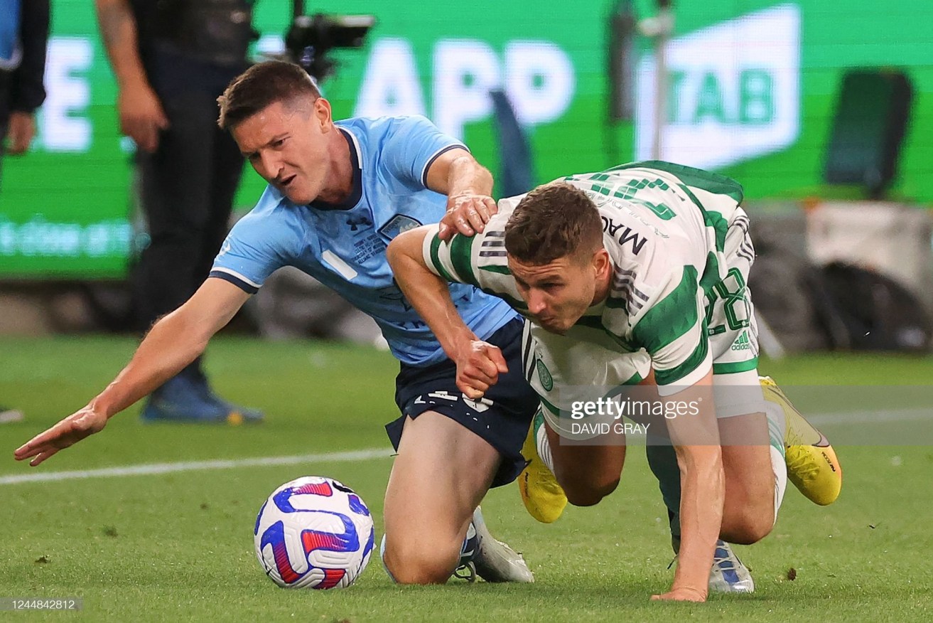 Sydney FC's Joseph Lolley [left]  and Celtic's Oliver Abildgaard fight for the ball at Allianz Stadium in Sydney.