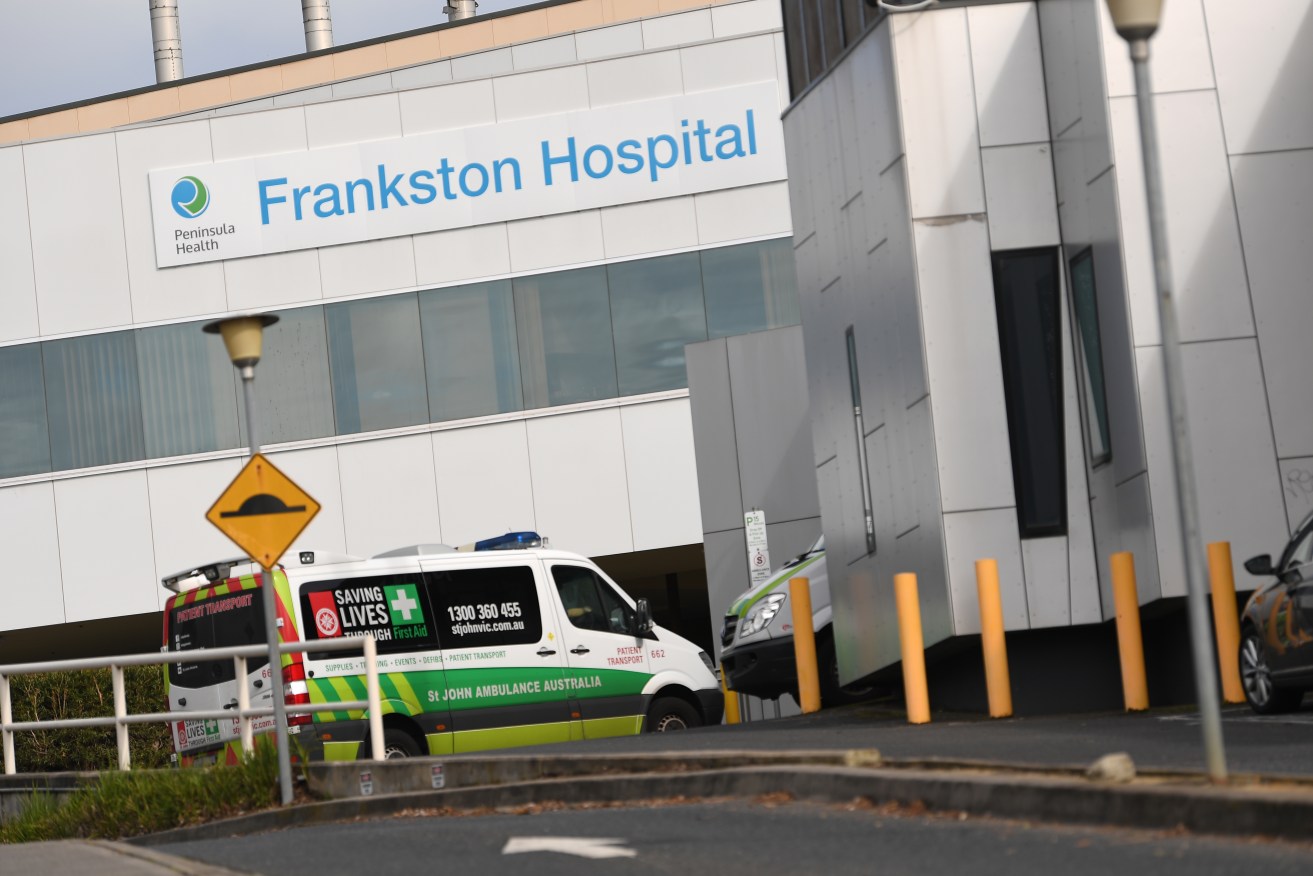 A crane has fallen on Melbourne's Frankston Hospital, prompting the evacuation of 70 people.