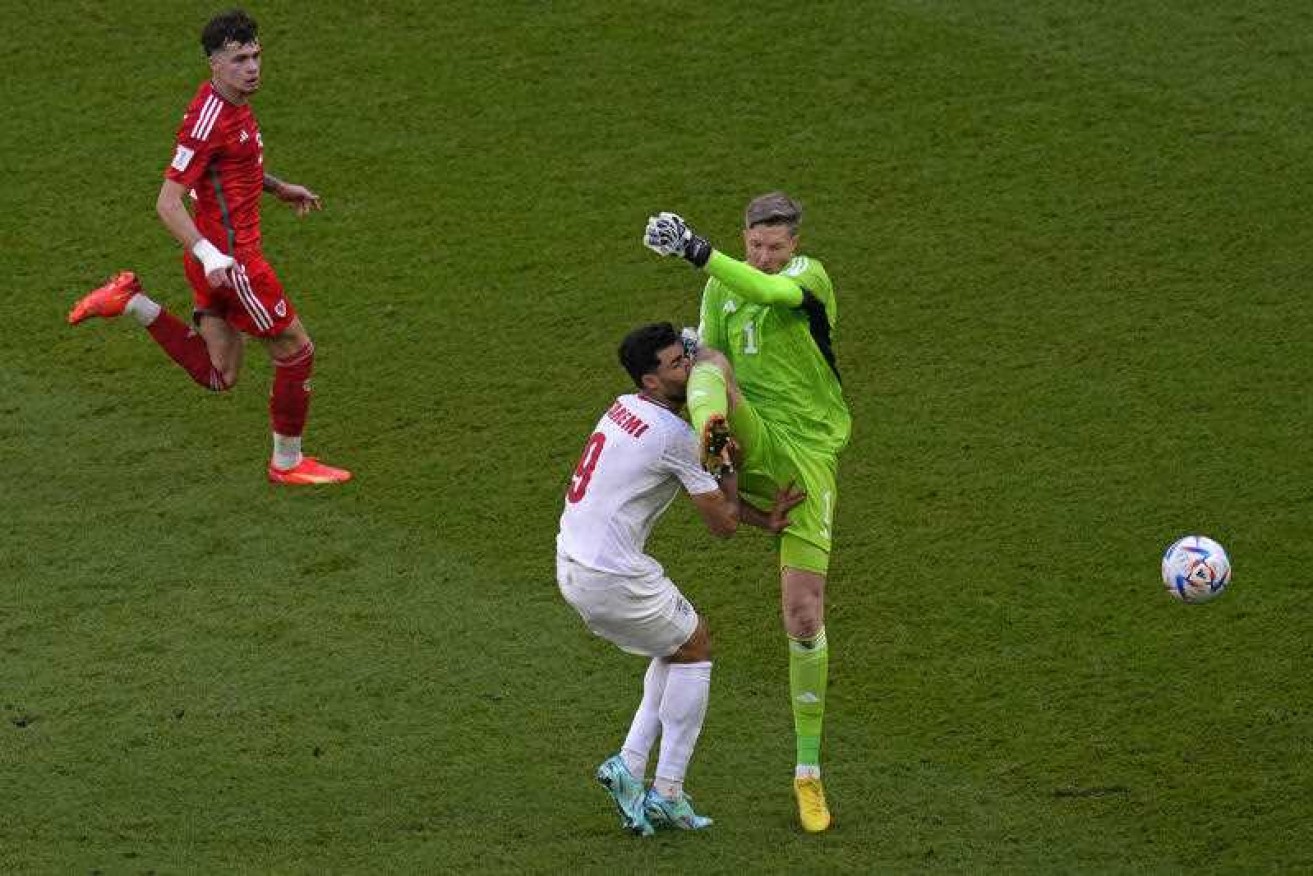 Wales goalkeeper Wayne Hennessey fouls Iran's Mehdi Taremi, which earned him a red card.