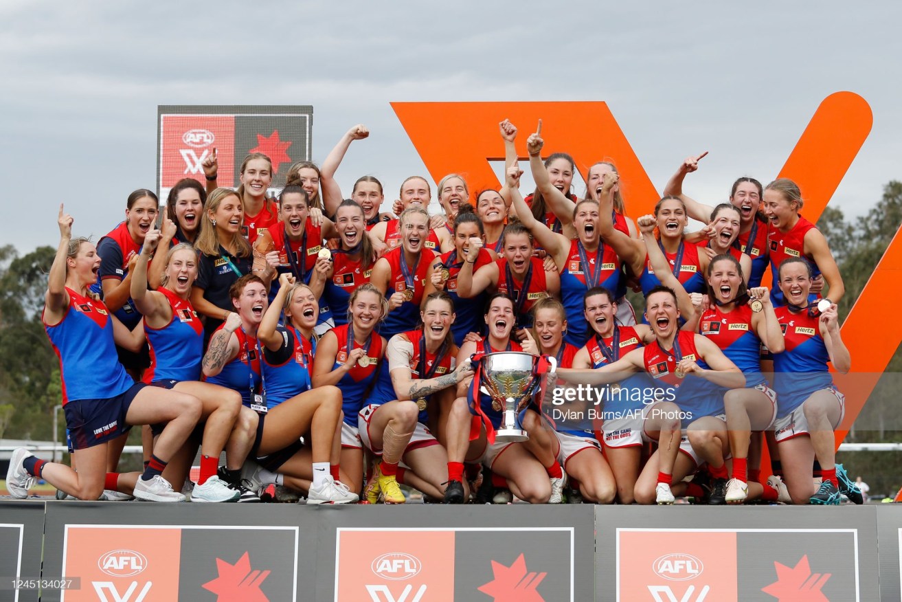 Melbourne Demons players celebrate their historic  AFLW grand final victory over Brisbane Lions in Ipswich. 