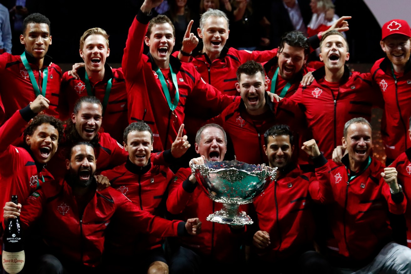 Team Canada celebrate with the trophy after winning the Davis Cup tennis final in Malaga, Spain.