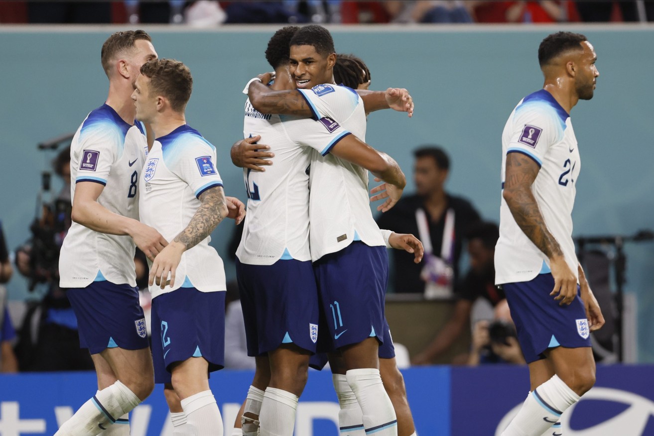 Two goals from Marcus Rashford have helped England top their World Cup group with a 3-0 win over Wales.