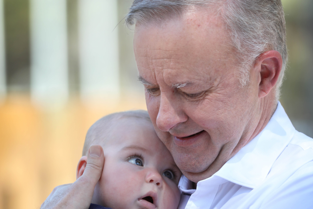 Little Mia Roper, who was born on election day, gets a cuddle from the PM in Renmark.