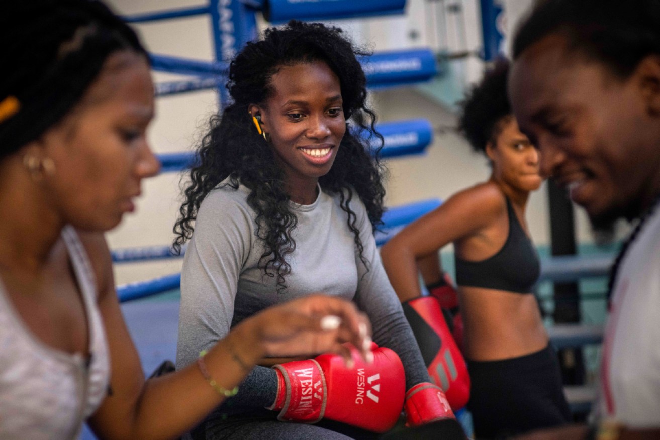 Legnis Cala, centre, talks with fellow female boxers during a training session in Havana, Cuba after officials announced on Monday that female boxers would be able to compete professionally in the country for the first time ever.