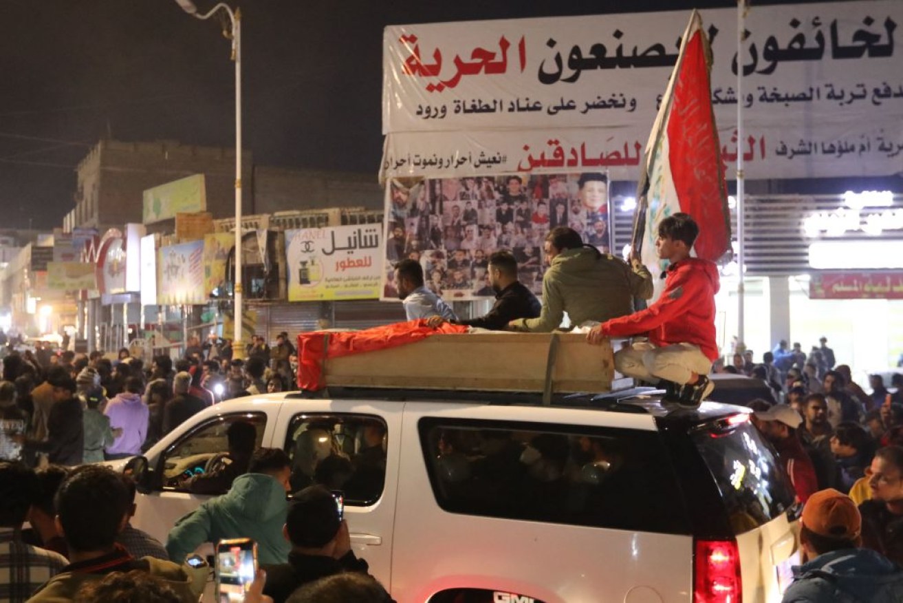 Mourners accompany the casket of one of the two protesters killed in clashes with security forces in the Iraqi city of Nasiriyah.