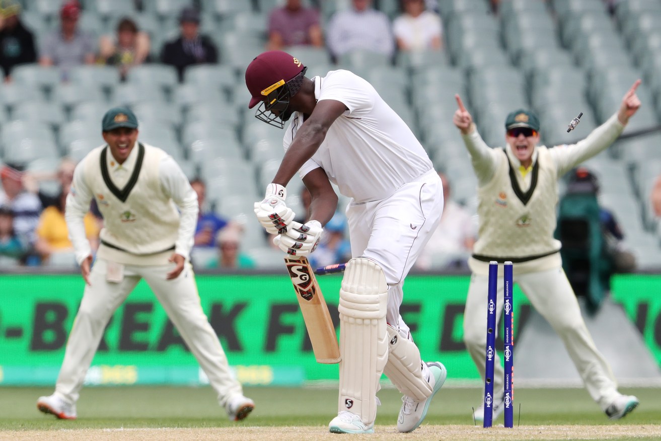  Jason Holder of the West Indies is clean bowled  by Mitchell Starc at the Adelaide Oval on Sunday. 