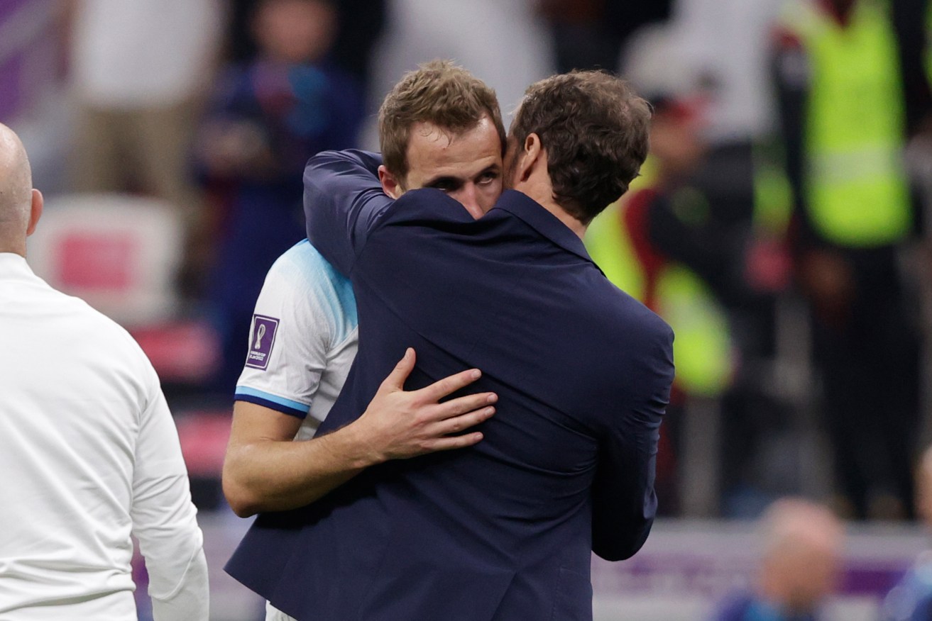 A dejected Harry Kane is comforted by England coach Gareth Southgate after the World Cup loss to France.