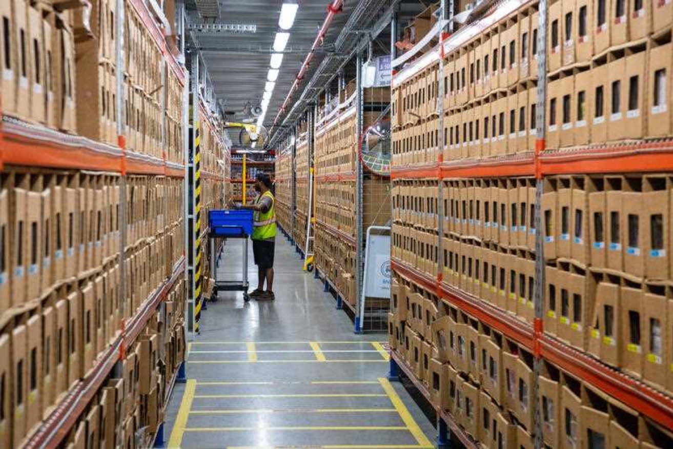 A worker moves goods at Amazon's warehouse in Brisbane, which is dispatching 30,000 packages a day.