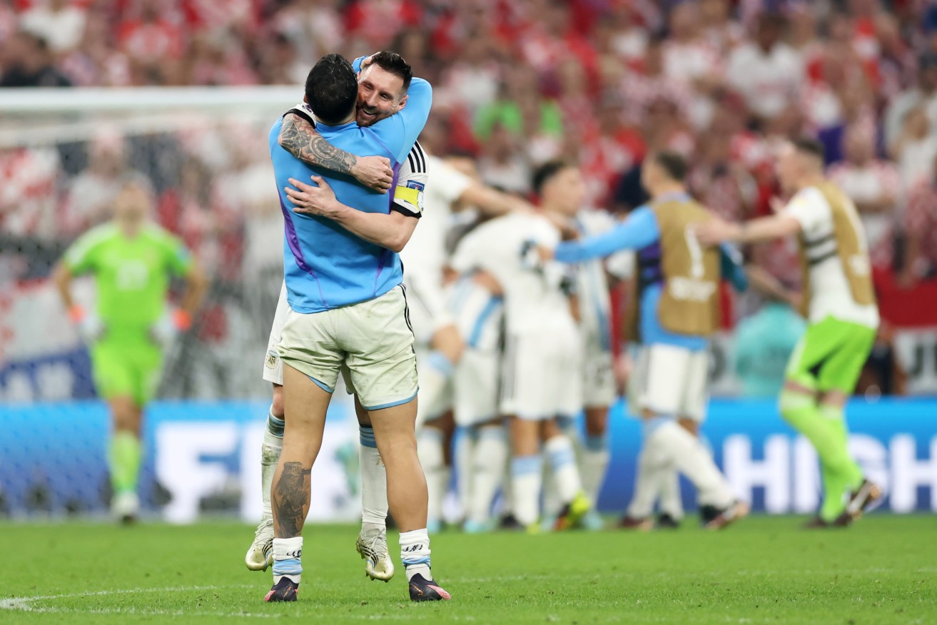 Lionel Messi celebrates Argentina's semifinal win with Leandro Paredes.