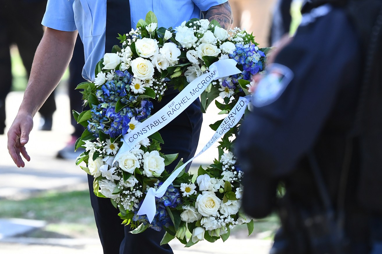 Police are massing for a service for two murdered officers due to begin soon in Brisbane.