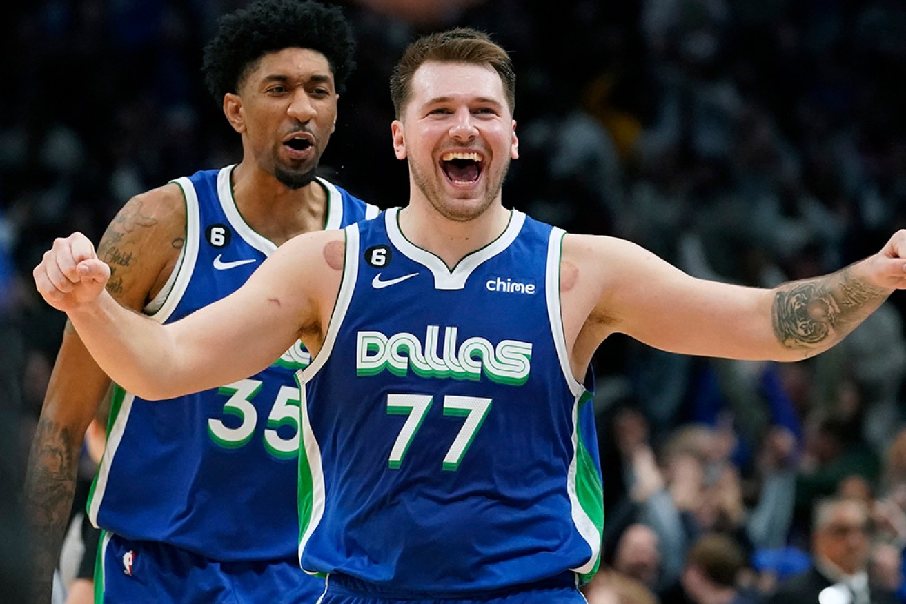 Luka Doncic celebrates his late game-tying basket in a historic NBA performance for Dallas. 