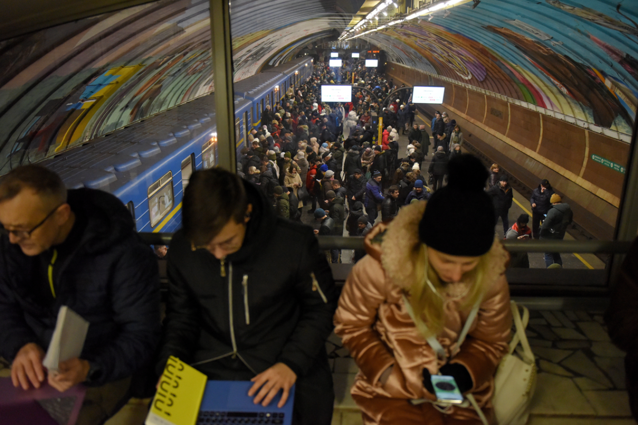 Kyiv residents try to get on with their lives while sheltering from Russia's latest blitz in the capital's subway system. <i>Photo: AAP</i>