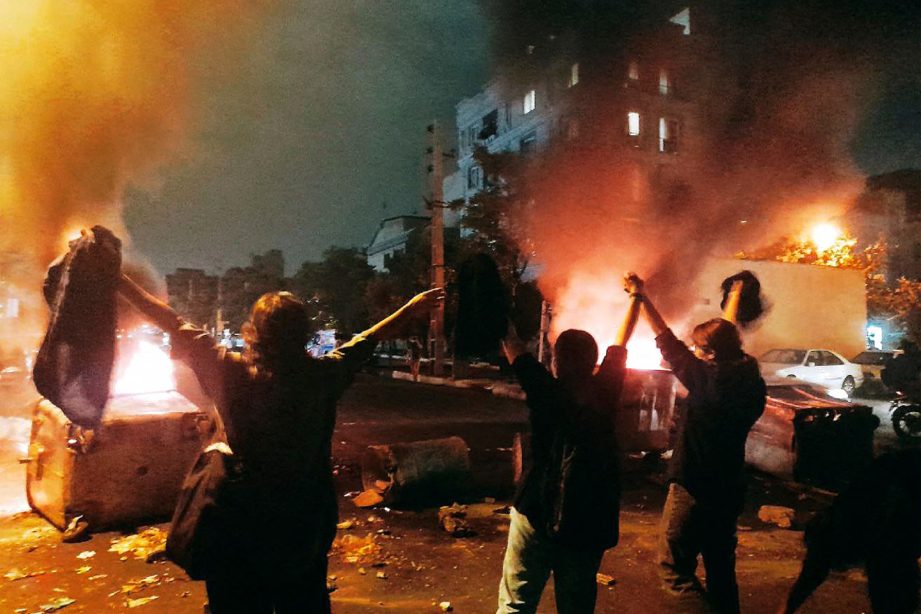 Iranian women remove their headscarf and clash with police during protest for Mahsa Amini, a woman who died after being arrested by the Islamic republic's "morality police", in Tehran