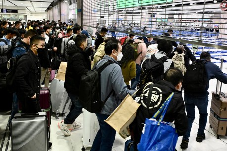 Travellers queue for passports as China opens
