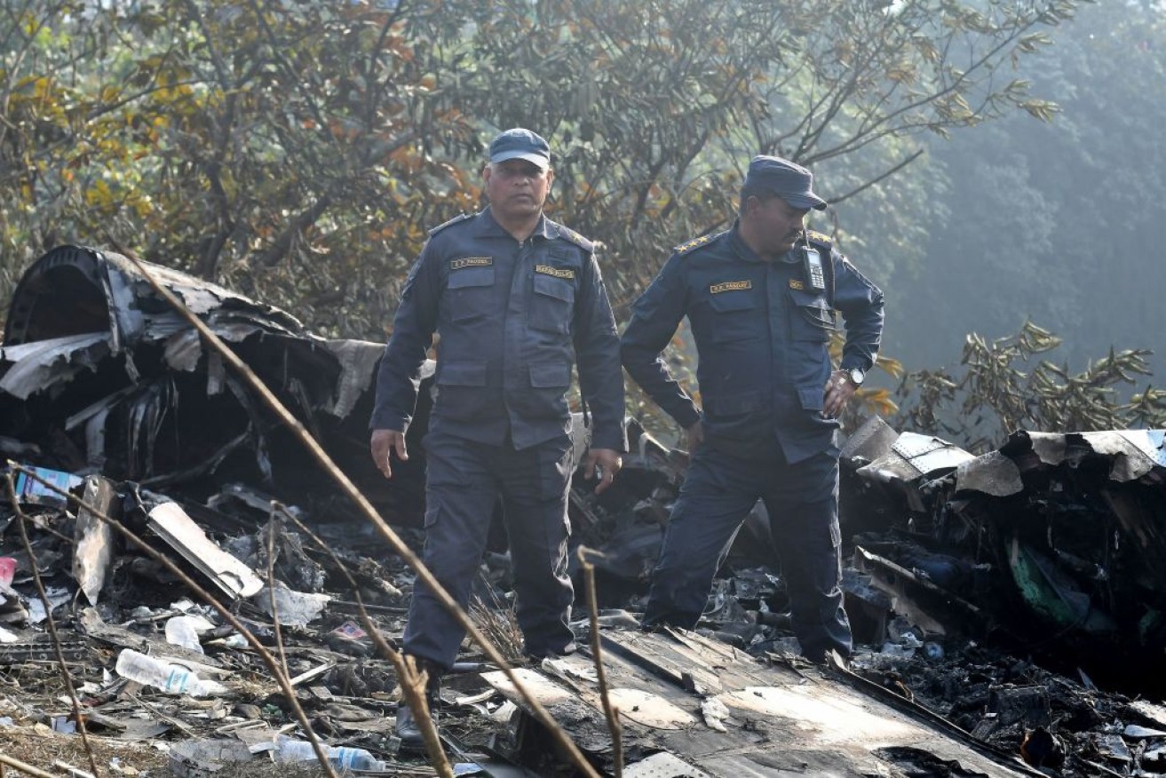 Rescuers inspect what was left of the plane.