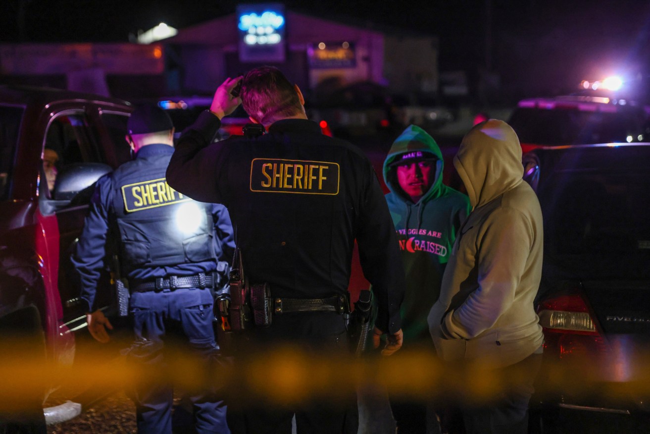 Sheriff's deputies at one of the scenes of where seven people died near San Francisco.