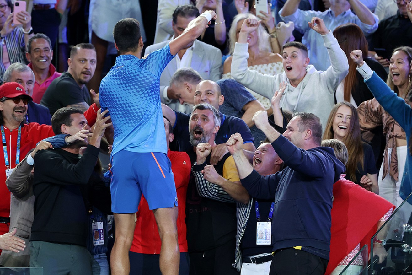 Serbian ace Novak Djokovic celebrates the win with his team at Melbourne Park on Sunday night. 