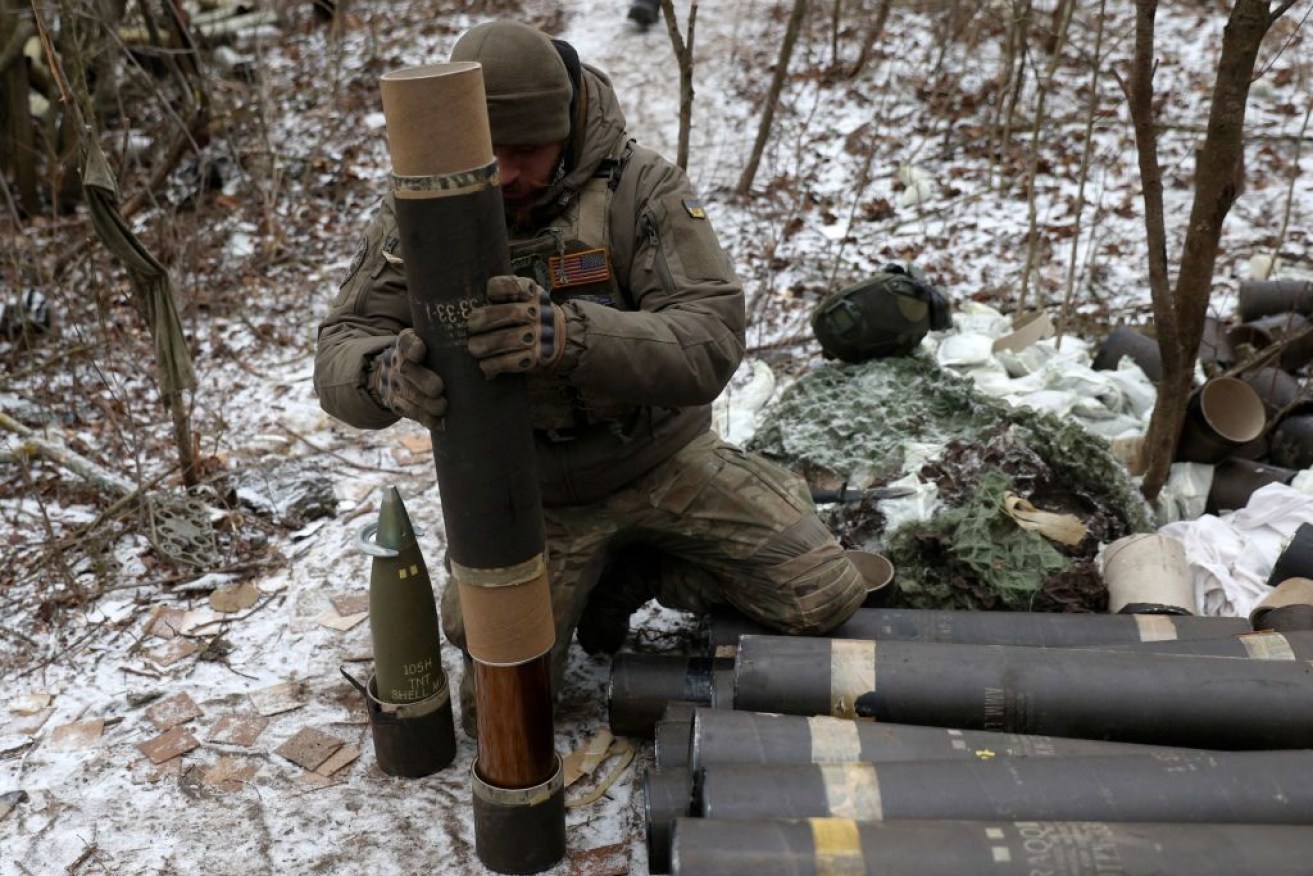 A Ukrainian artilleryman prepares one of the embattled nation's dwindling supply of artillery shells. <i> Photo: Getty</i>