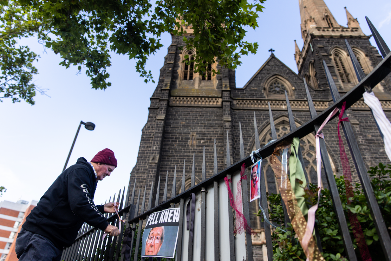 A protester adds his ribbon to the collection outside the memorial service for George Pell, <i>Photo: AAP</i>
