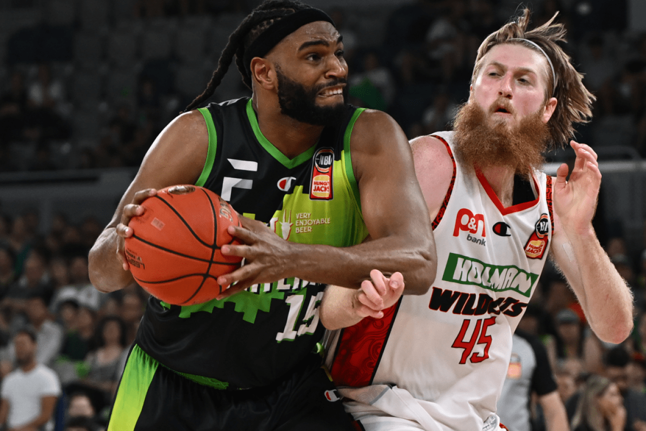 Alan Williams of the Pheonix (left) jostles with  Brady Manek in the game's final, thrilling seconds. <i>Photo: AAP</i>