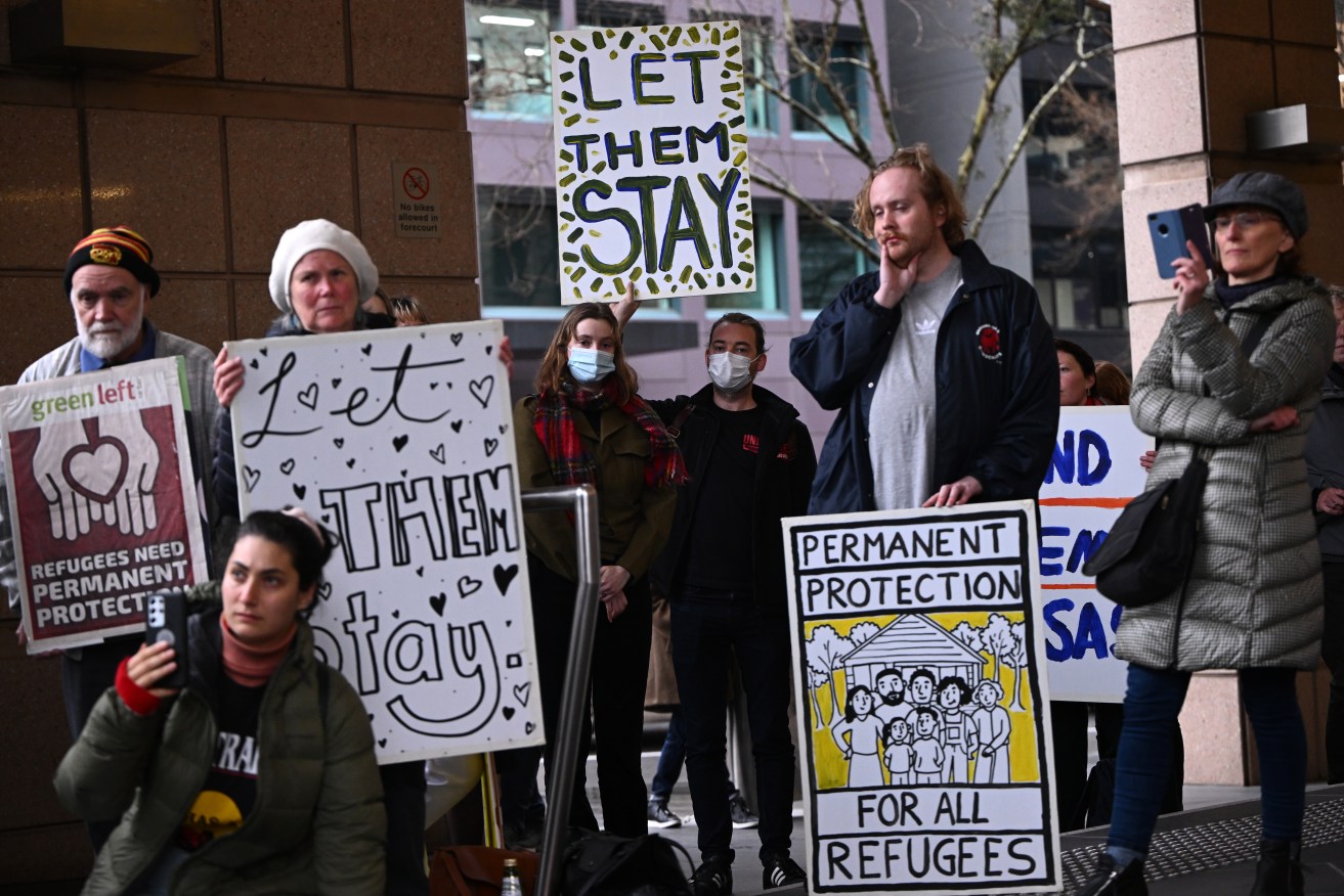Refugees and supporters rally outside the Immigration Department in Melbourne in 2022.