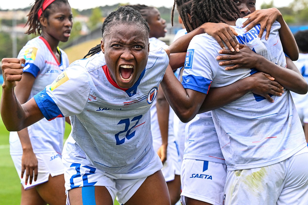 Roselord Borgella celebrates a Haiti goal as it beat Chile to qualify for the Women's World Cup.