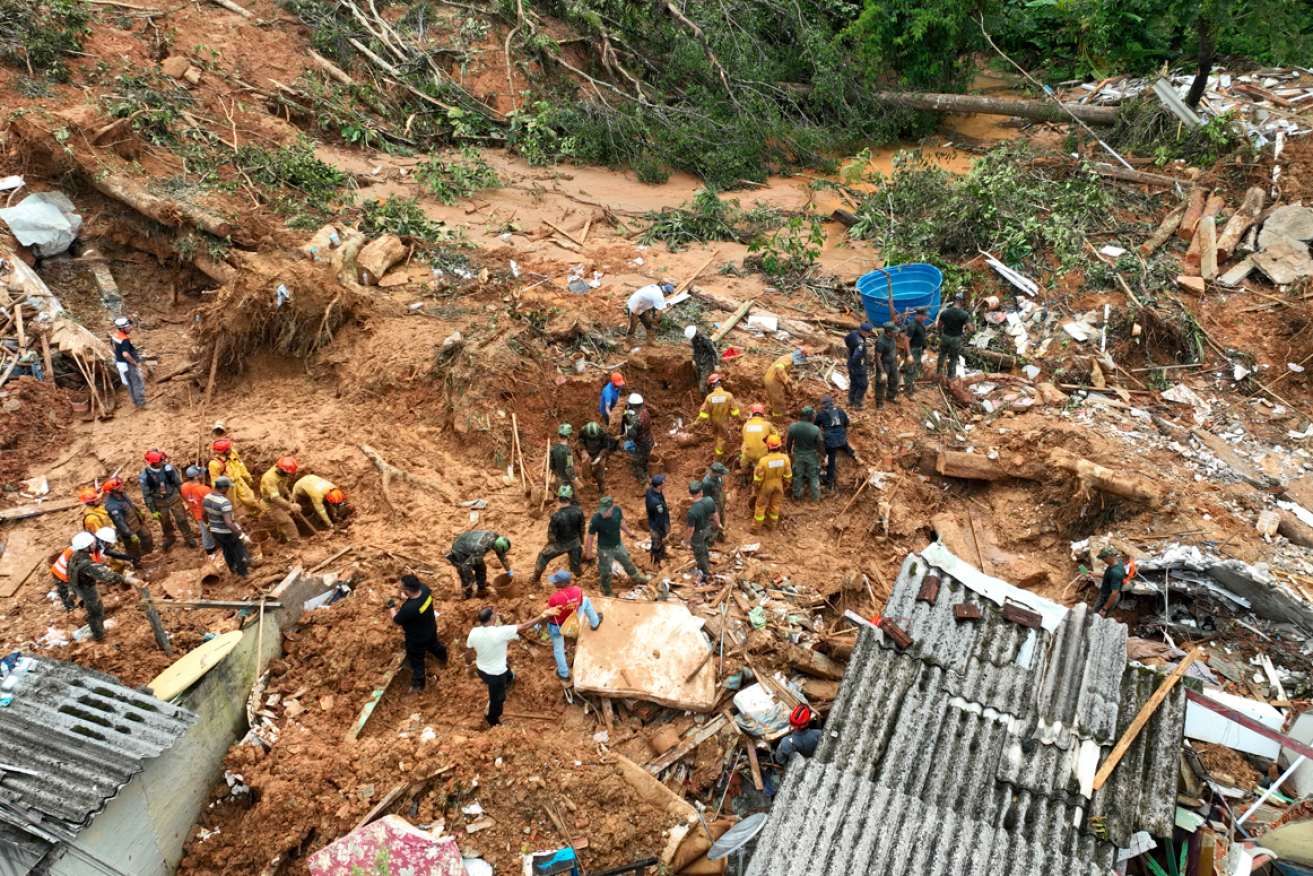 Rescue workers look for bodies after a landslide triggered by heavy rains near Barra do Sahy beach in the coastal city of Sao Sebastiao. <i>Photo: AAP</i>