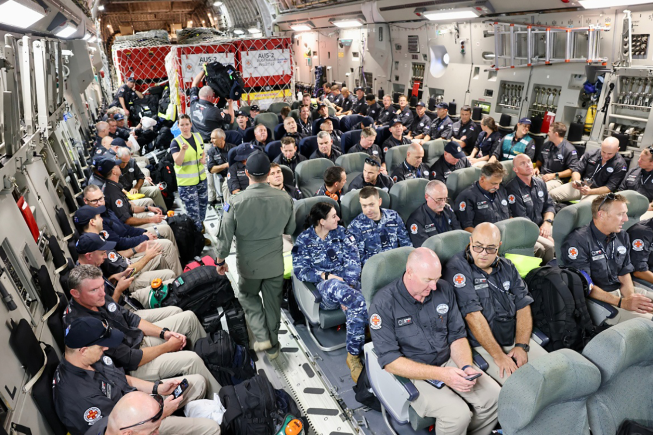 The Aussie volunteers settle in for the long flight home aboard a military transport. <i>Photo: FRNSW</i>