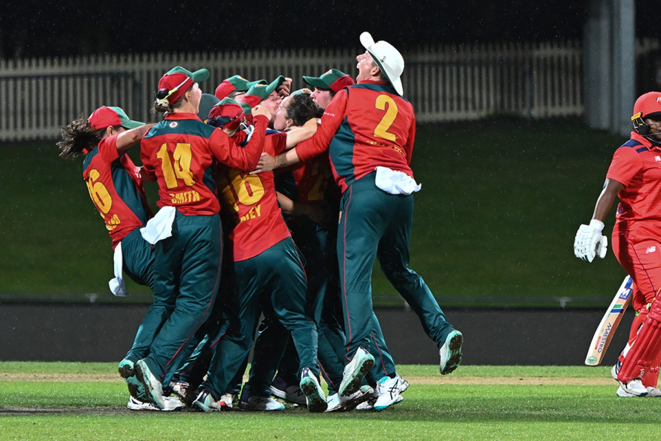 Tasmanian Tigers mob Sarah Coyte after her stunning final over on Saturday night.