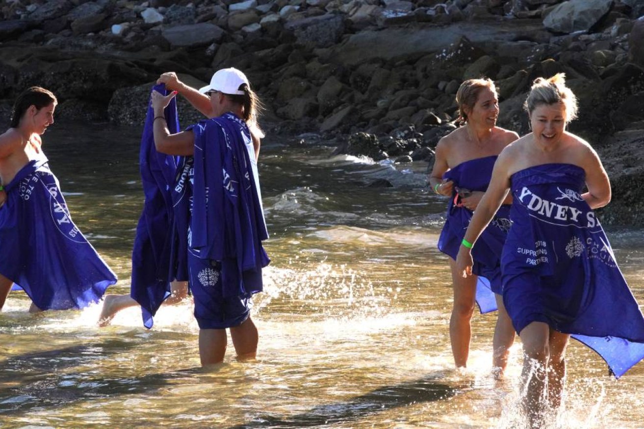 Nude swimmers participate in the 2018 Sydney Skinny Swim at Cobblers Beach.