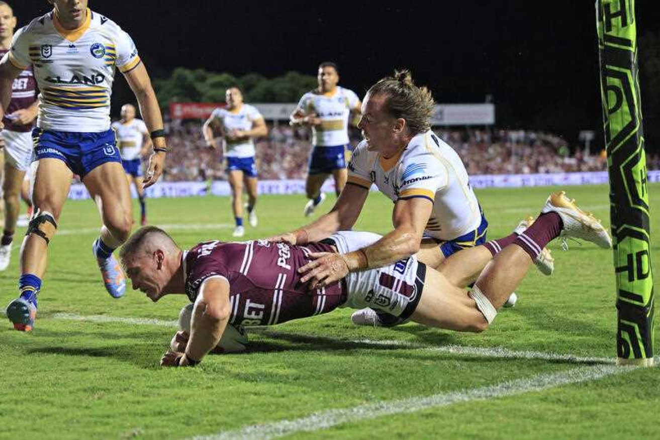 Sea Eagles winger Reuben Garrick scores a try in Manly's 34-30 win over Parramatta on Thursday night. 