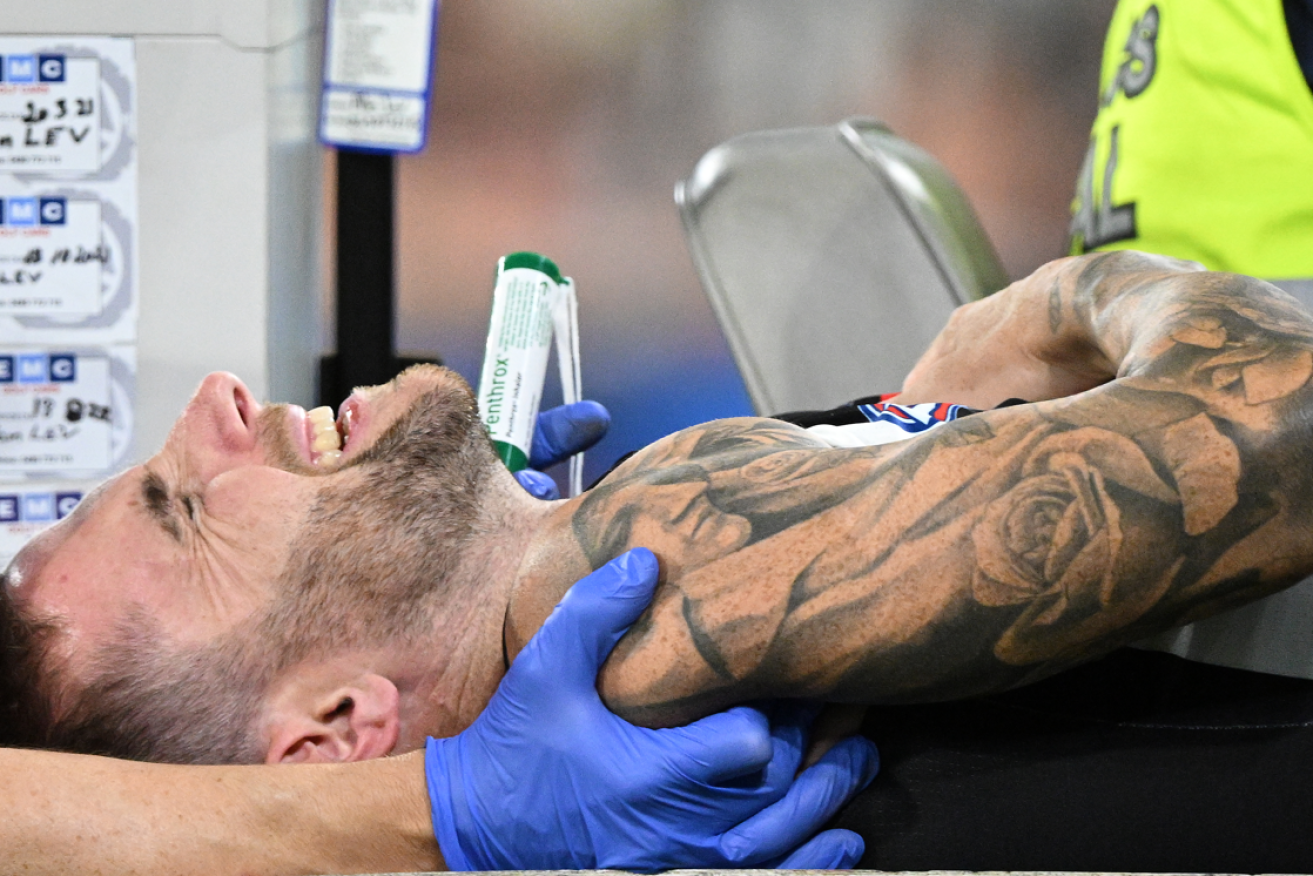 Jeremy Howe grimaces in pain as he is wheeled from the arena en route to hospital with a compound arm fracture. <i>Photo: AAP</i>