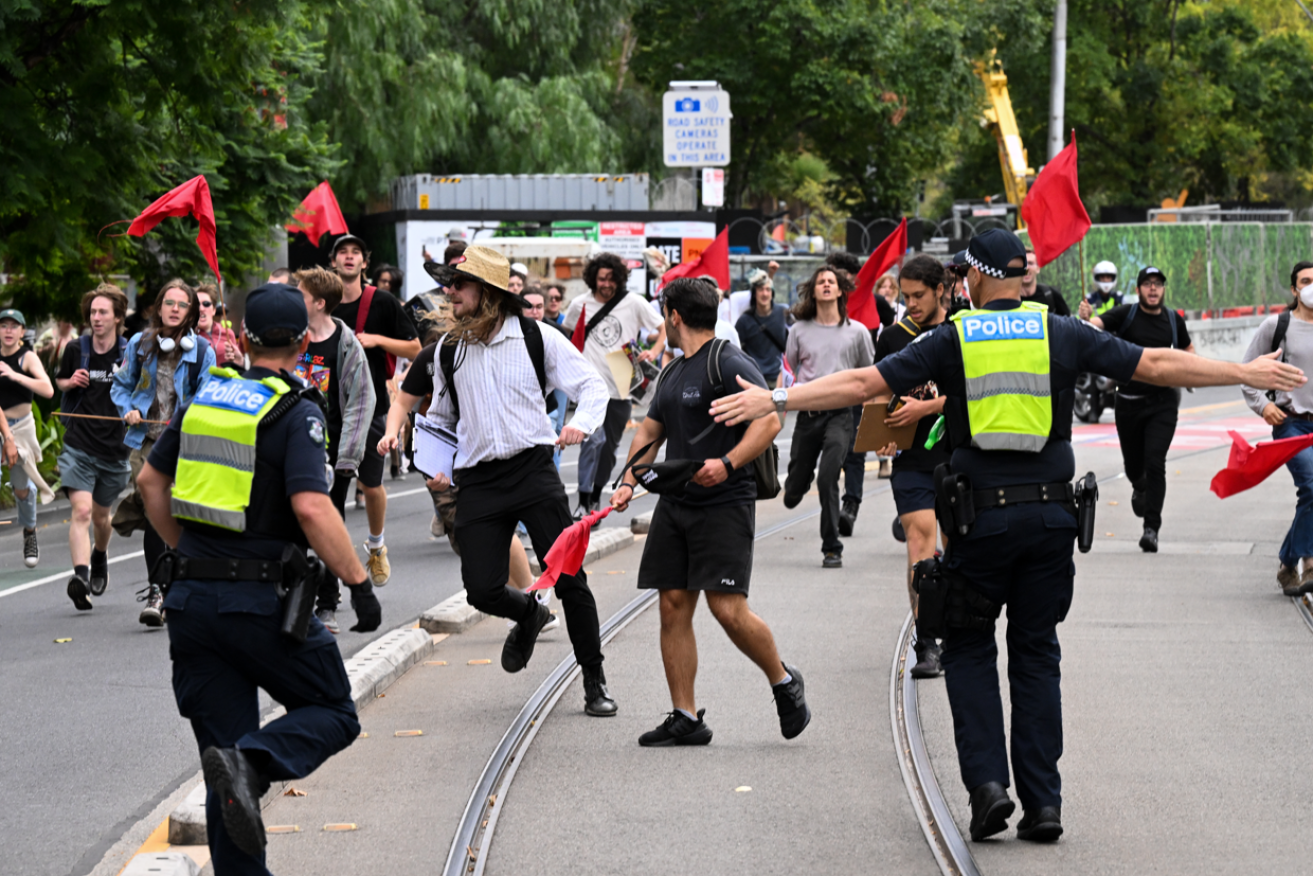 Transgender rights supporters run to confront neo-Nazi in Melbourne as police try to keep the groups apart. <i>Photo: AAP</i>