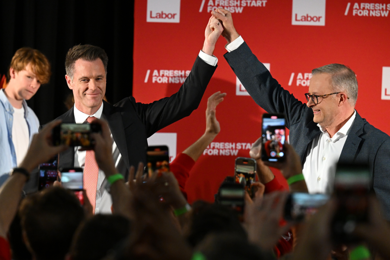 Jubilant PM Anthony Albanese holds high the hand of NSW's next premier Chris Minns. <i>Photo: AAP</i>