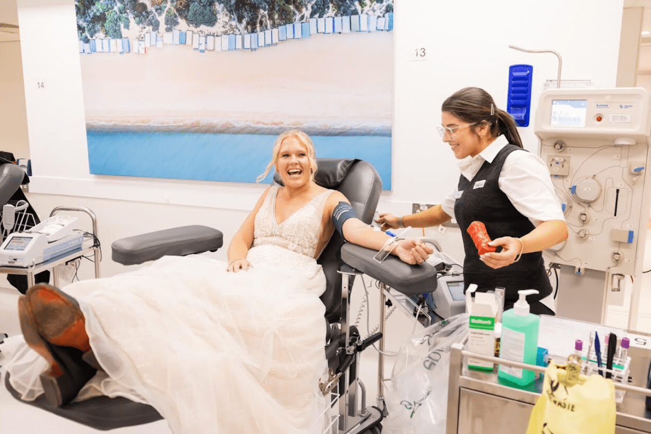Newlywed Sarah Willets puts her arm where her heart is and celebrates her wedding with a blood donation. <i>Photo: AAP</i>