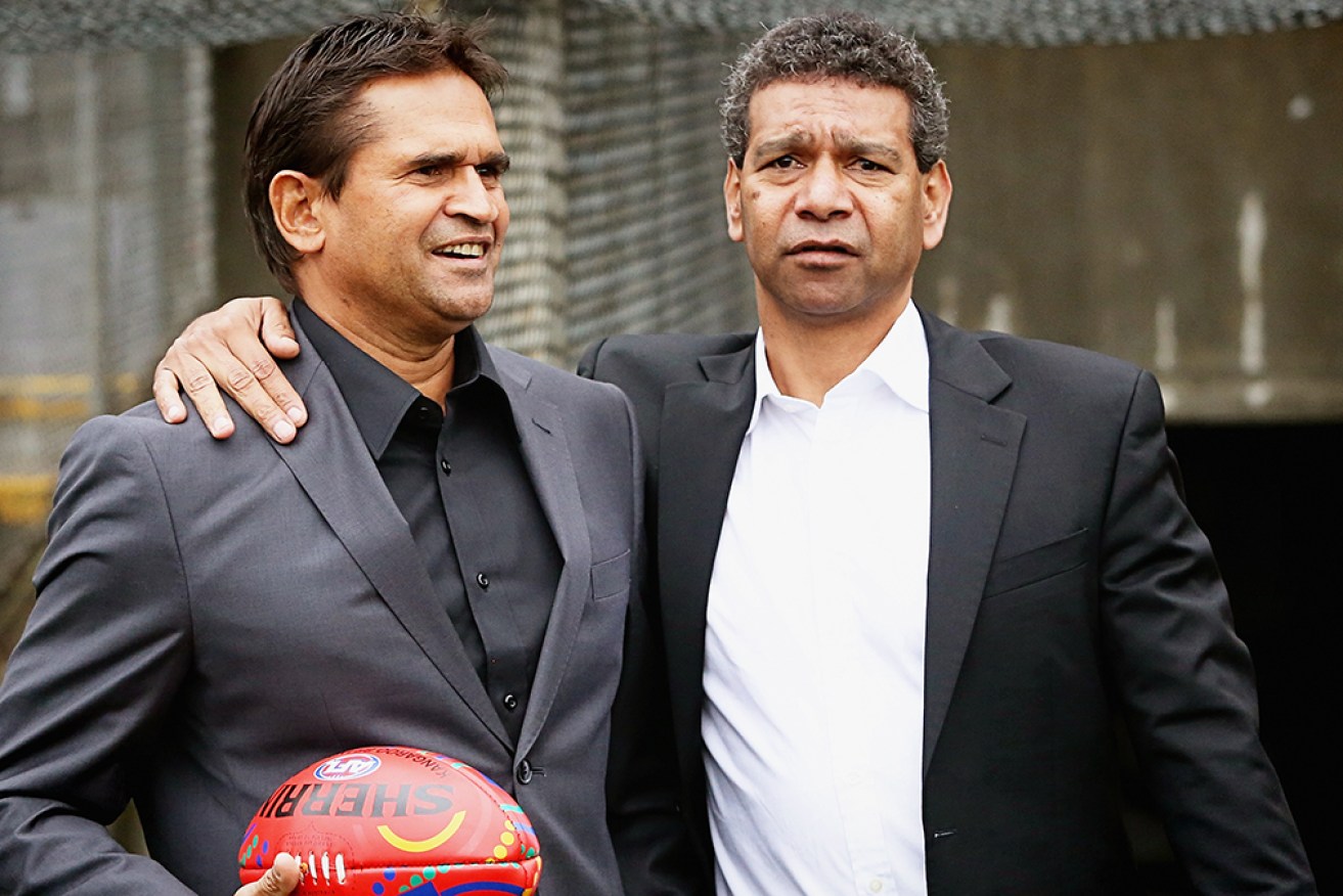 Collingwood has apologised to former Saints Nicky Winmar and Gilbert McAdam over racist abuse.