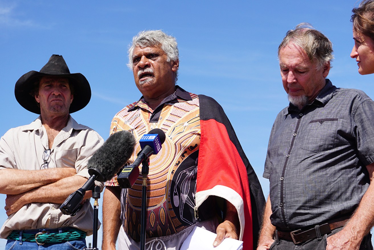 Larrakia traditional owner Eric Fejo (centre) was among those protesting the onshore drilling rig. 