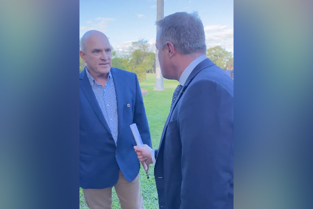 Former Goldstein MP Tim Wilson (right) in a confrontation with a Zoe Daniel volunteer, Peter, at Sunday's commemoration.