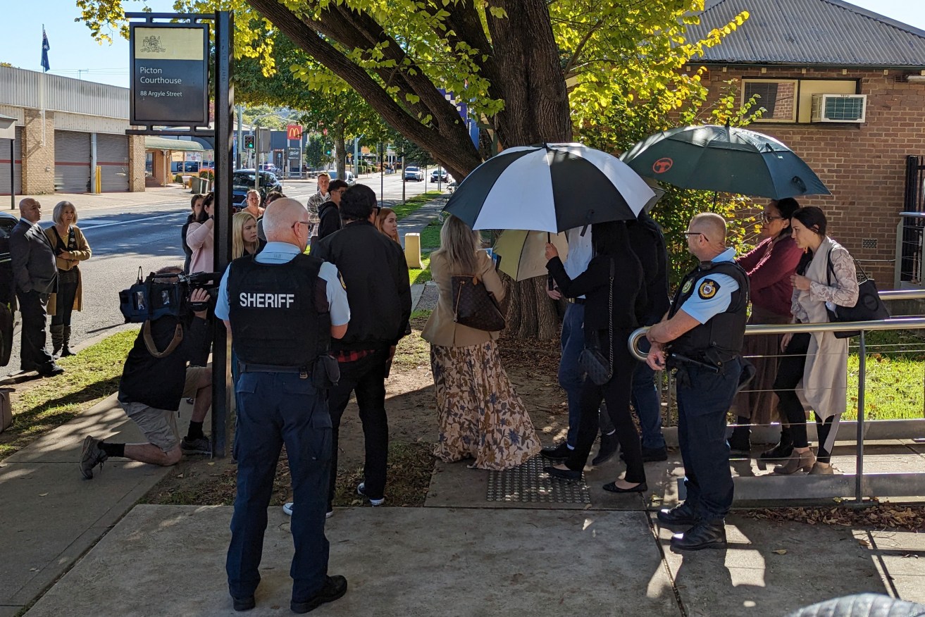 Tyrell Edwards appeared in court but entered and left the building with umbrellas hiding his face.