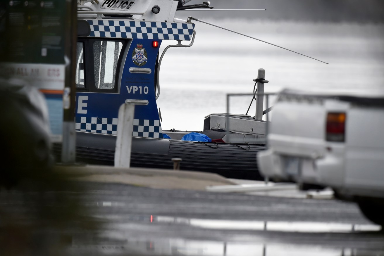 Police were called to a burning boat which sunk in Port Phillip where two people have been rescued.