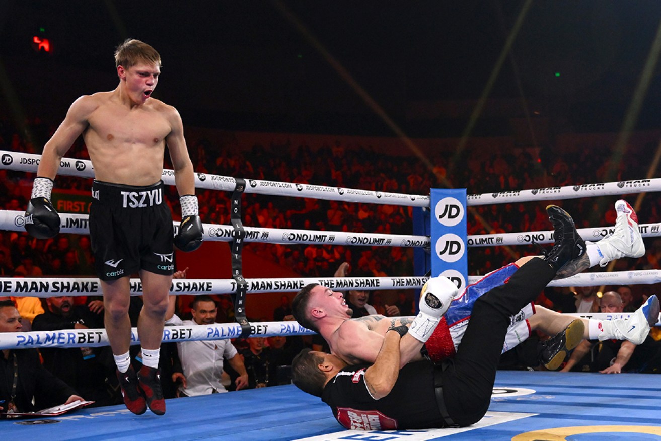Nikita Tszyu knocks down Benjamin Bommber, who lands on the referee in their super-welterweight bout.