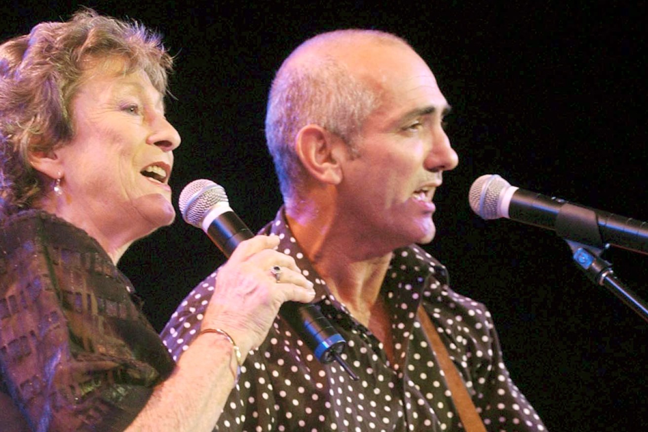 Joy McKean sings with another Australian music legend, Paul Kelly, on stage in Tamworth in 2004.