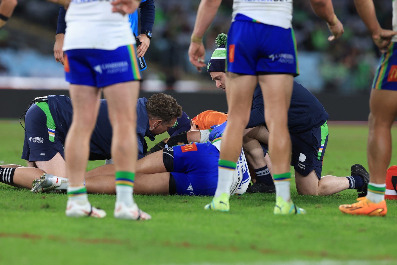Players stand around Corey Harawira-Naera of the Raiders after his shock collapse.
