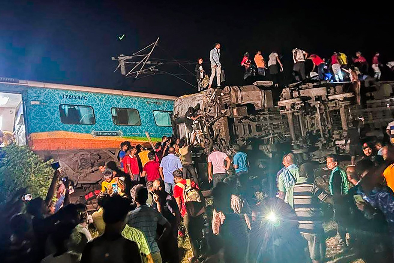Rescuers are examining the mangled wreck of one of the trains in a collision to find survivors.