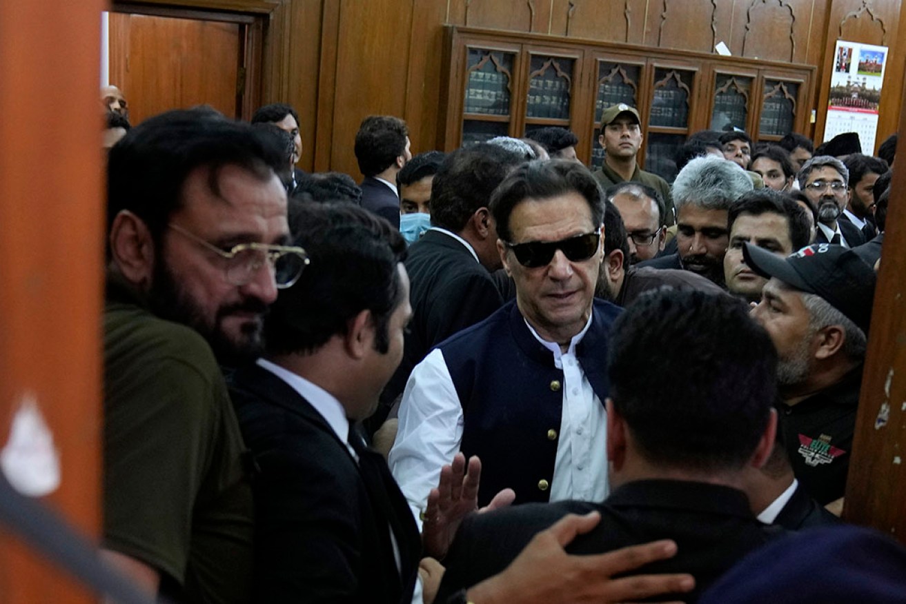 Pakistan's former PM Imran Khan leaves court after being granted bail on murder charges. 