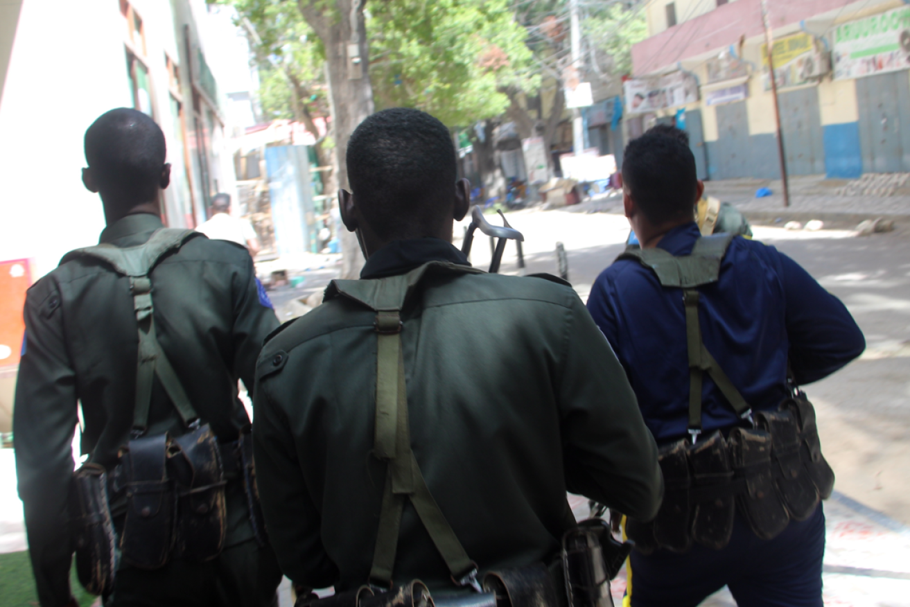 Somali troops move cautiously towards the Pearl restaurant after the Islamic militants' attack.
